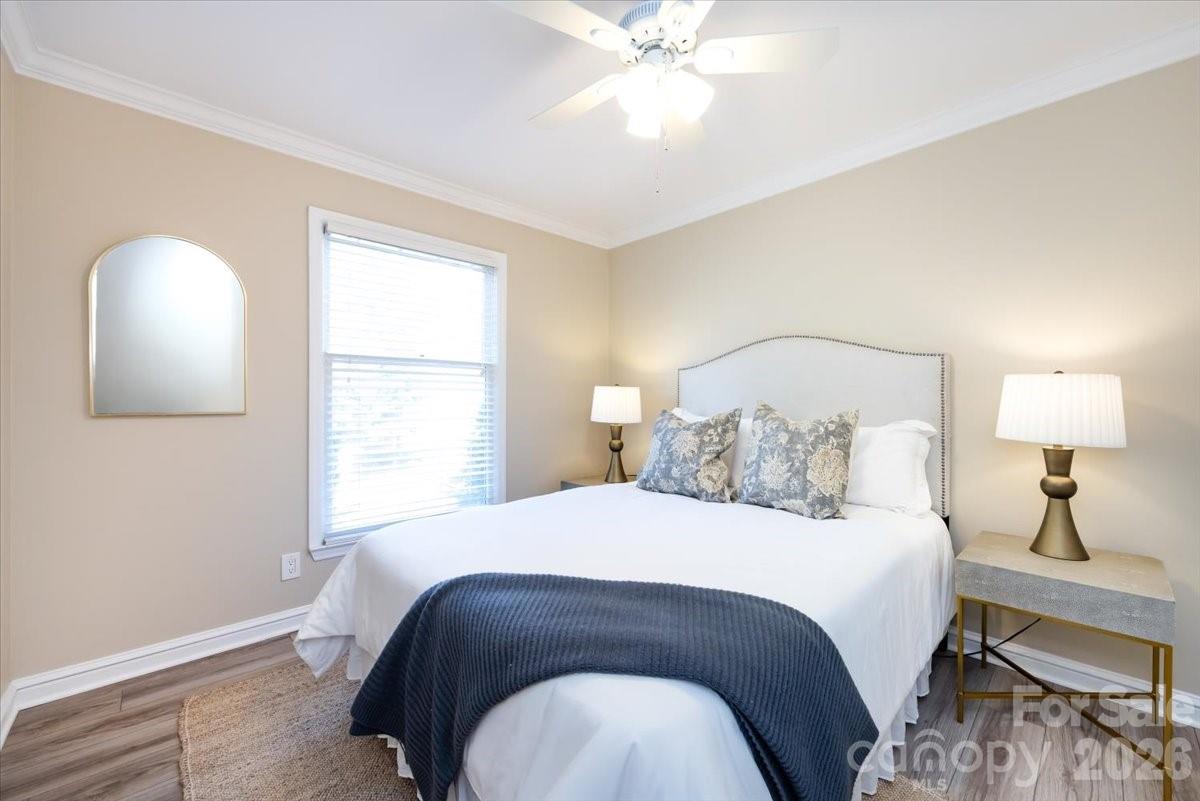430 Queens Road, Unit 221 Charlotte, NC 28207 - Photo 16 of 21 a bedroom with a bed and a mirror
