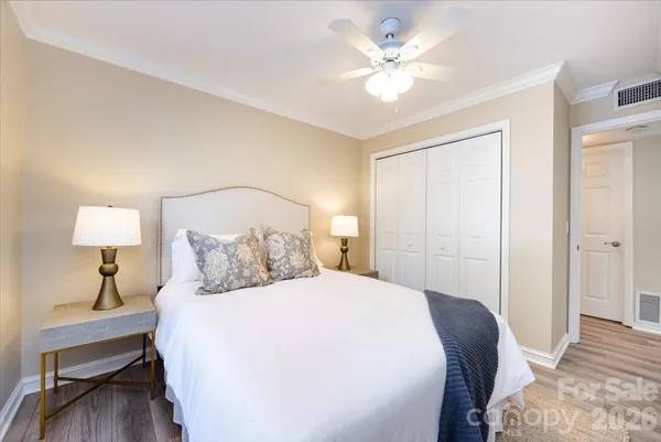 a bedroom with a large bed and a lamp