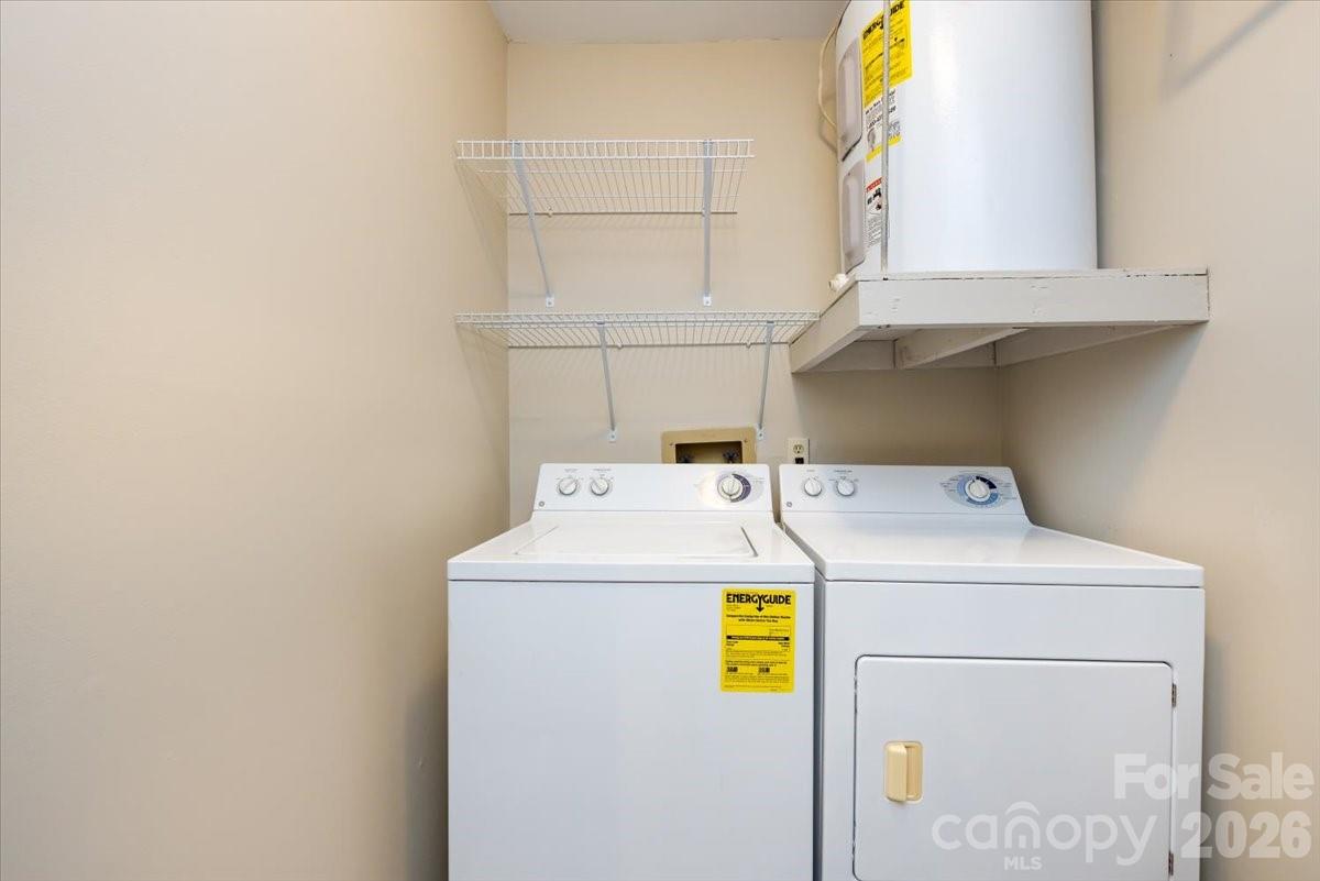 430 Queens Road, Unit 221 Charlotte, NC 28207 - Photo 19 of 21 a utility room with dryer and washer