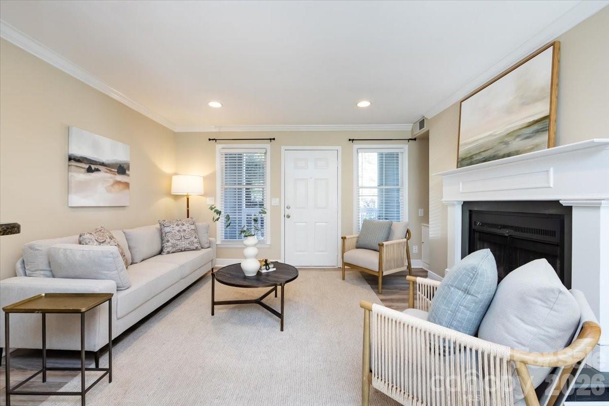 430 Queens Road, Unit 221 Charlotte, NC 28207 - Photo 2 of 21 a living room with furniture and a fireplace