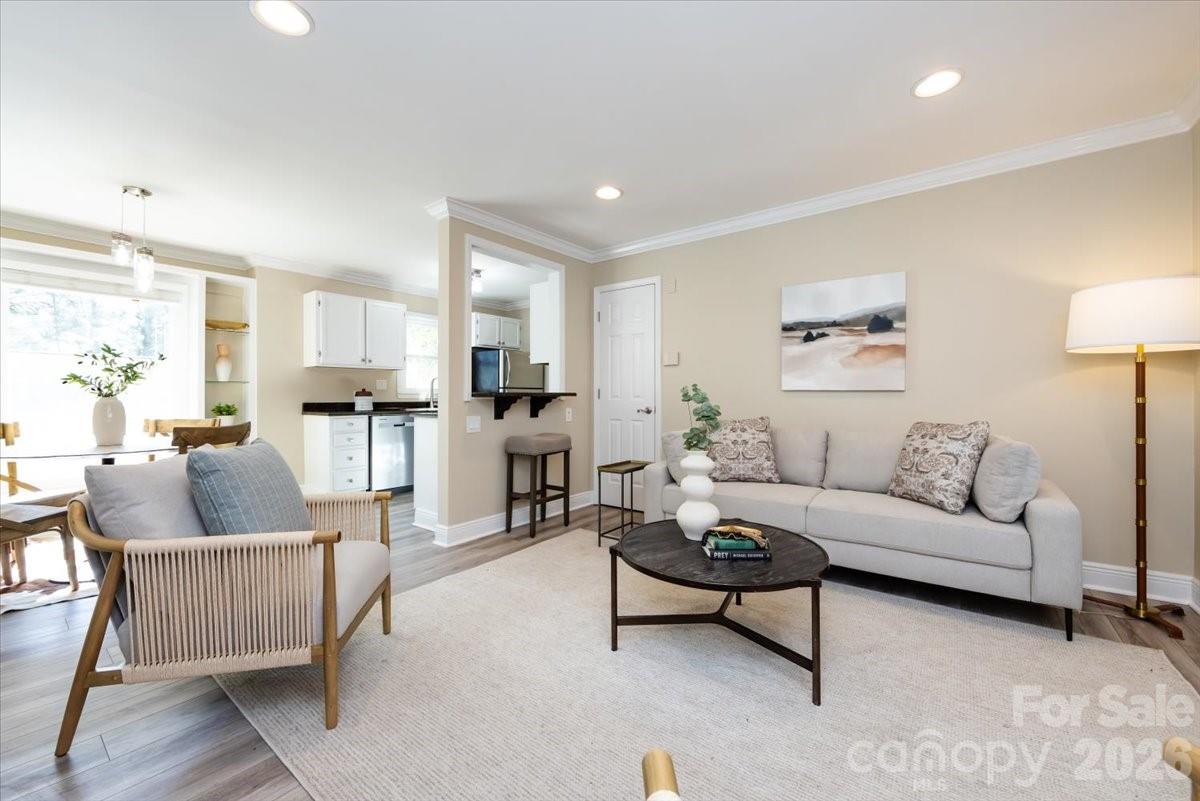 430 Queens Road, Unit 221 Charlotte, NC 28207 - Photo 5 of 21 a living room with furniture and kitchen view with wooden floor