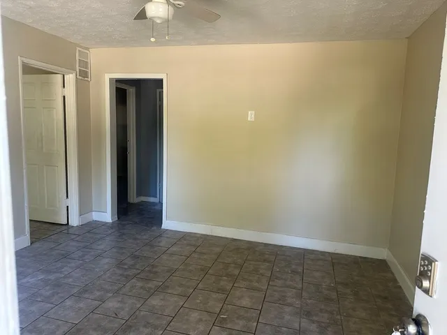 an empty room with a bench and a window