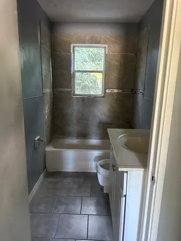 a bathroom with a bathtub and toilet
