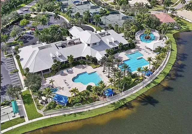 an aerial view of residential houses with outdoor space and trees