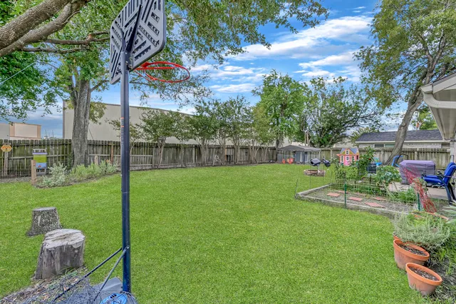 a view of yard with swimming pool and green space