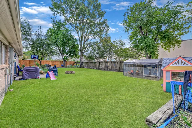 a view of a house with a backyard and a patio