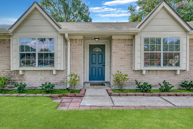 a front view of a house with a garden