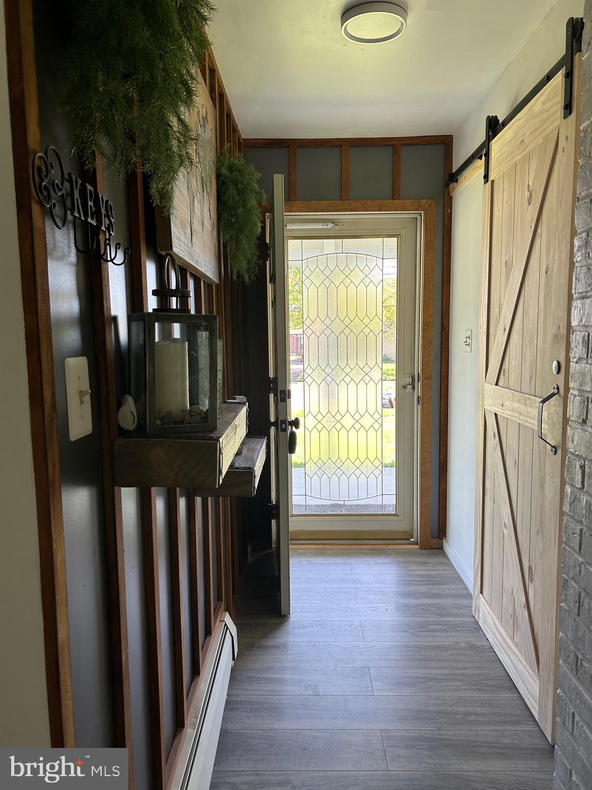 a view of entryway with a door and wooden floor