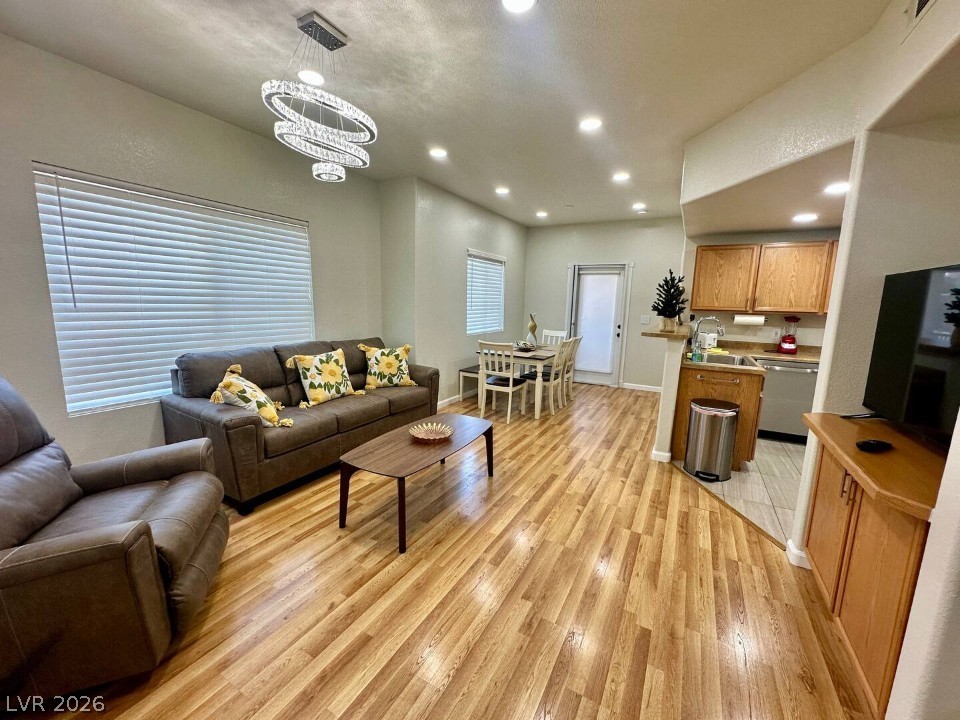 9580 West Reno Avenue, Unit 169 Las Vegas, NV 89148 - Photo 1 of 15 Luminous living space featuring polished hardwood-style flooring and recessed lighting.