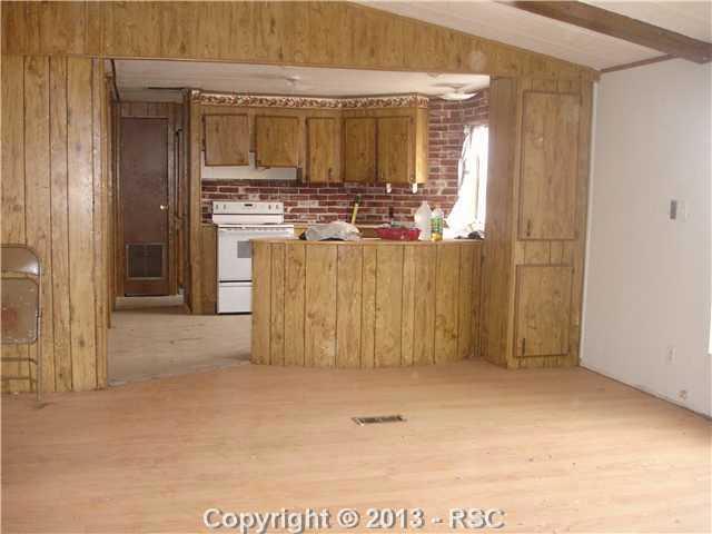 3315 Wiesner Road Calhan, CO 80808 - Photo 6 of 23 This is the other side of the Family Room. This is a nice kitchen with range oven included. As you can see, there is still some cleaning up to do.