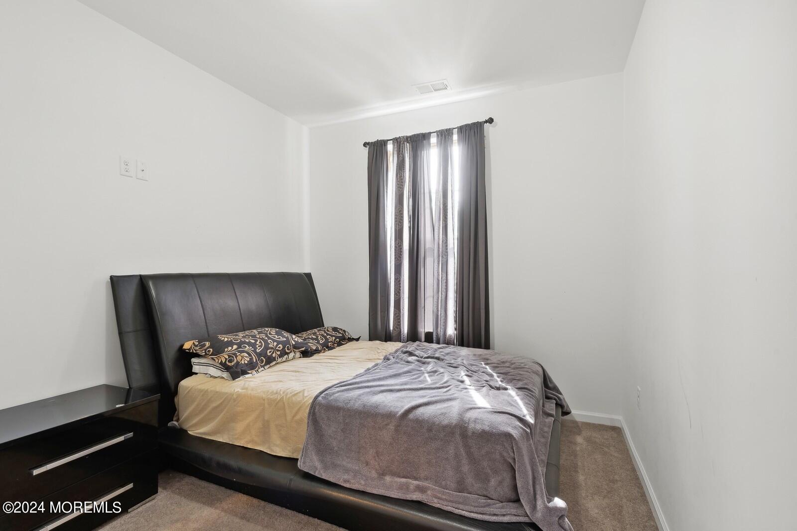 309 Revival Road Brick, NJ 08723 - Photo 18 of 37 a bedroom with a bed and a night stand