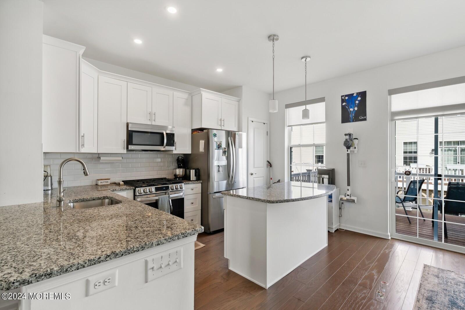 309 Revival Road Brick, NJ 08723 - Photo 2 of 37 a kitchen with stainless steel appliances granite countertop a sink refrigerator and microwave