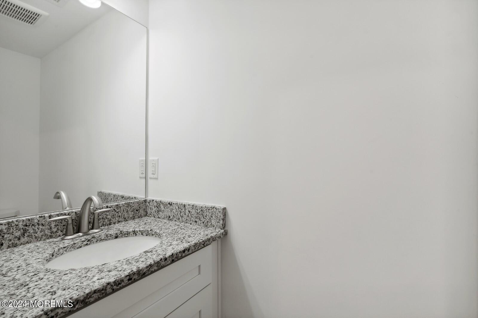 309 Revival Road Brick, NJ 08723 - Photo 23 of 37 a bathroom with a granite countertop sink and a mirror