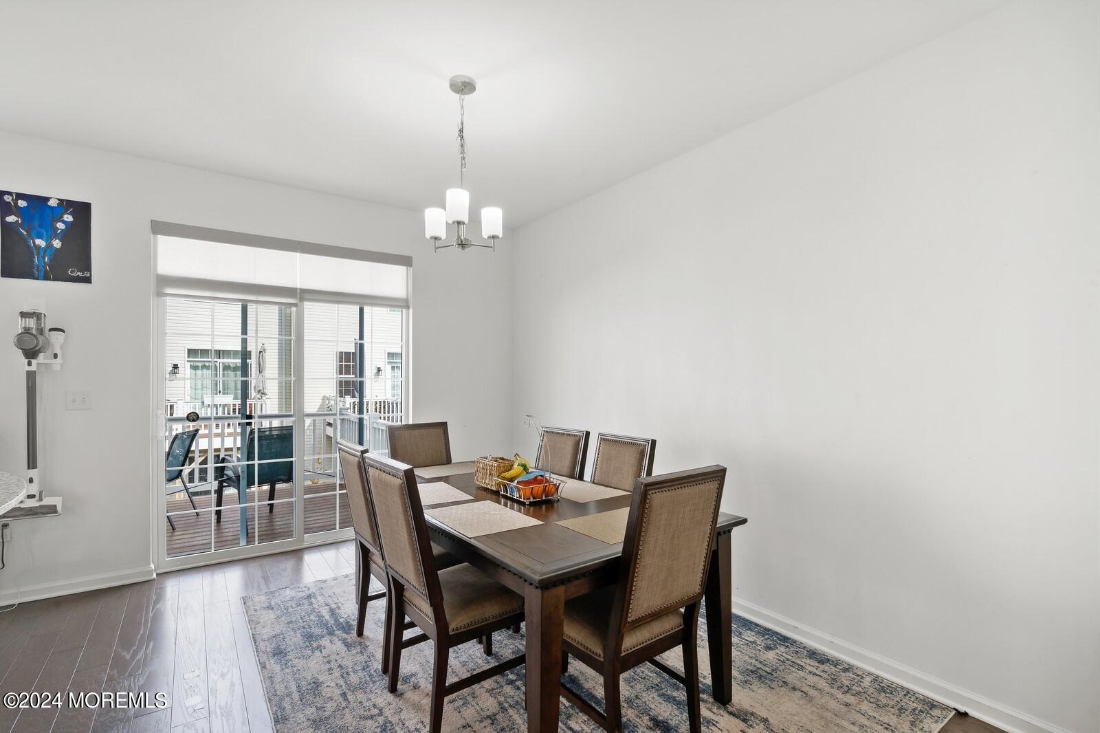 309 Revival Road Brick, NJ 08723 - Photo 5 of 37 a view of a dining room with furniture wooden floor and chandelier