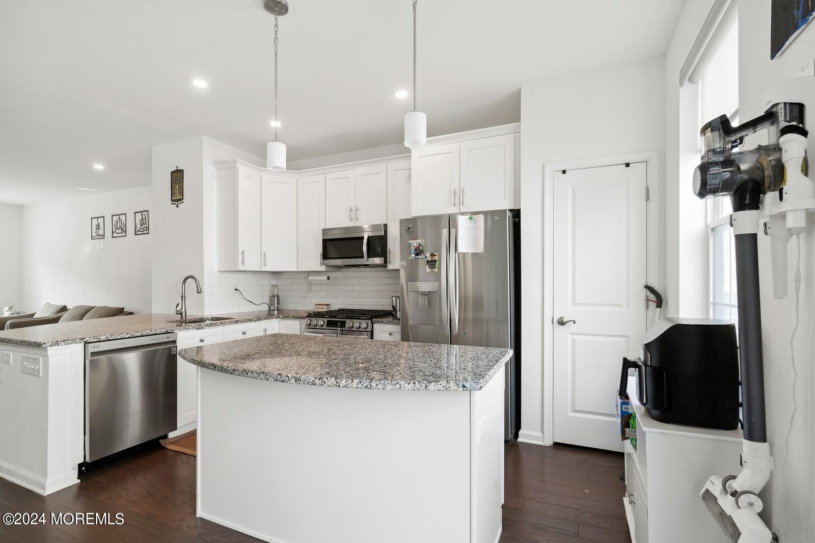 309 Revival Road Brick, NJ 08723 - Photo 9 of 37 a kitchen with stainless steel appliances granite countertop a sink a stove a refrigerator and cabinets