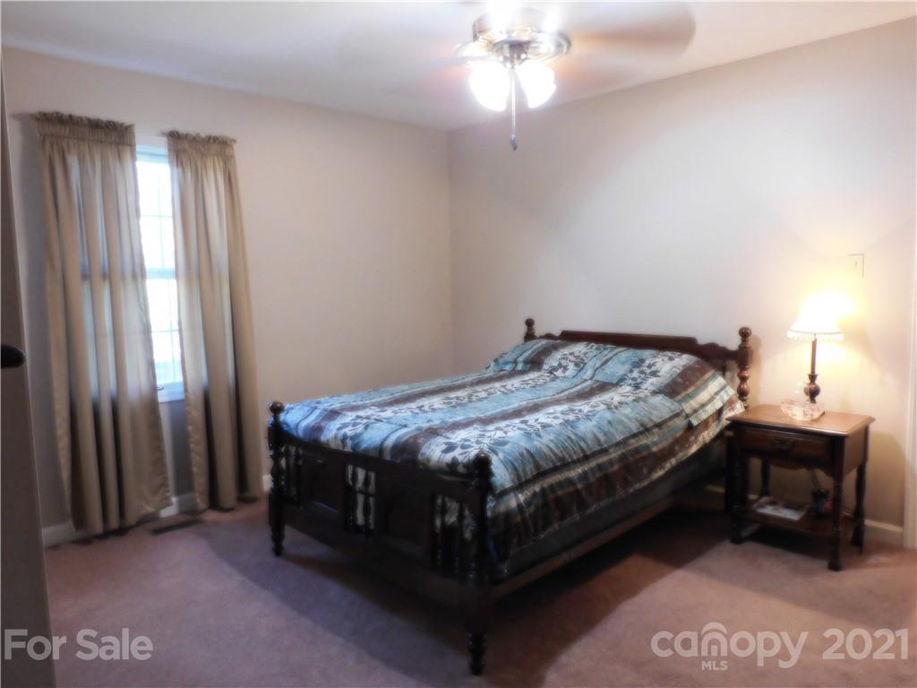 3800 Sherer Road Sharon, SC 29742 - Photo 21 of 42 a bedroom with a bed and a chandelier