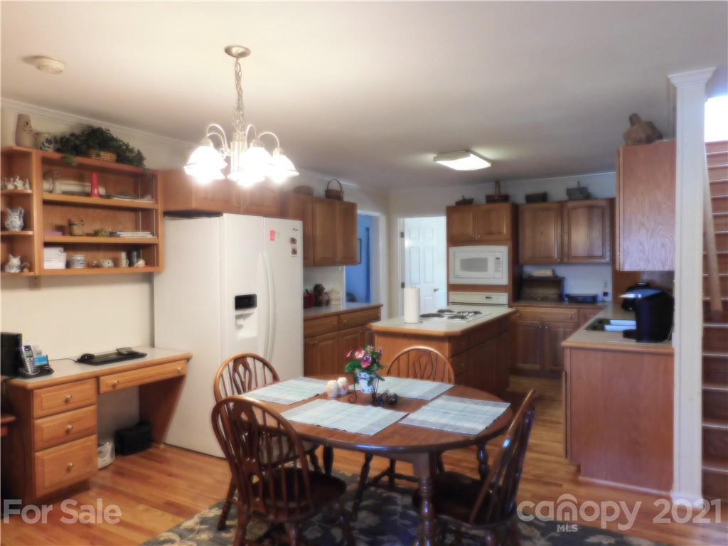3800 Sherer Road Sharon, SC 29742 - Photo 10 of 42 a kitchen with stainless steel appliances kitchen island granite countertop a table chairs and a refrigerator