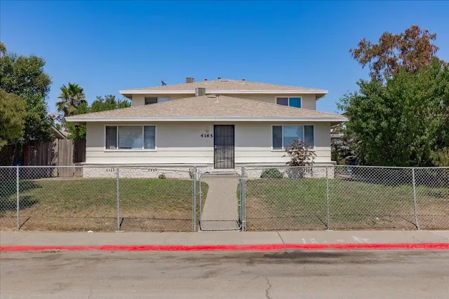 a house view with swimming pool and glass top table
