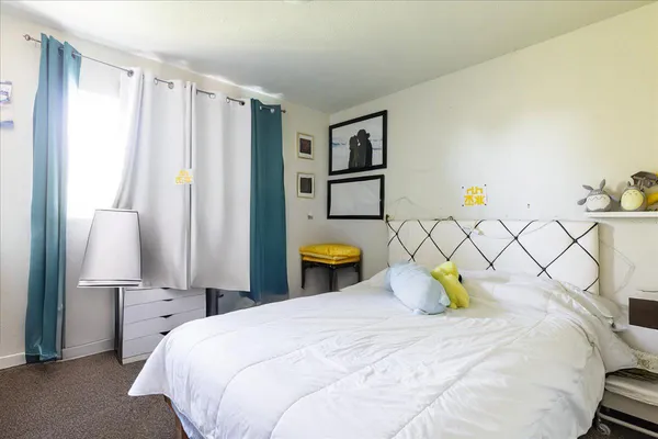 a bedroom with a bed and a lamp on table