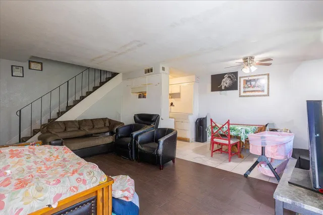 a living room with furniture and a baby crib