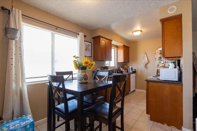 a kitchen with a sink a stove and chairs