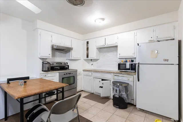 a kitchen with a stove a sink and a refrigerator