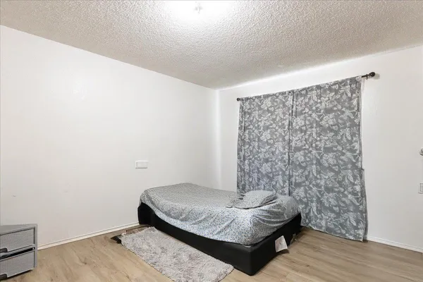 a bedroom with a bed and a mirror