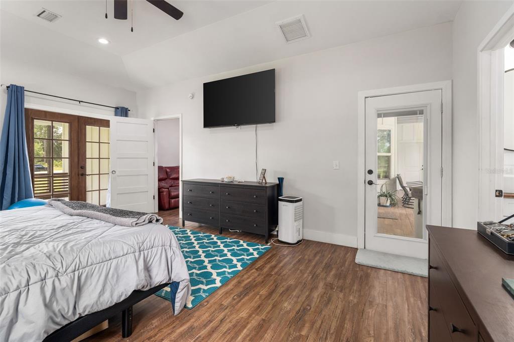 15971 Southeast 64th Street Lake Butler, FL 32054 - Photo 13 of 44 a bedroom with a bed and a flat screen tv