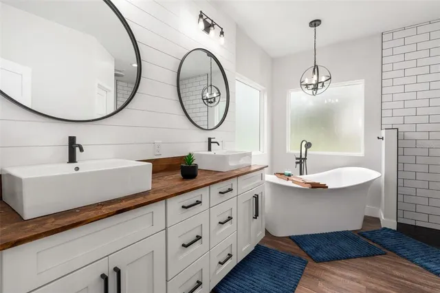 a bathroom with a double vanity sink and a mirror