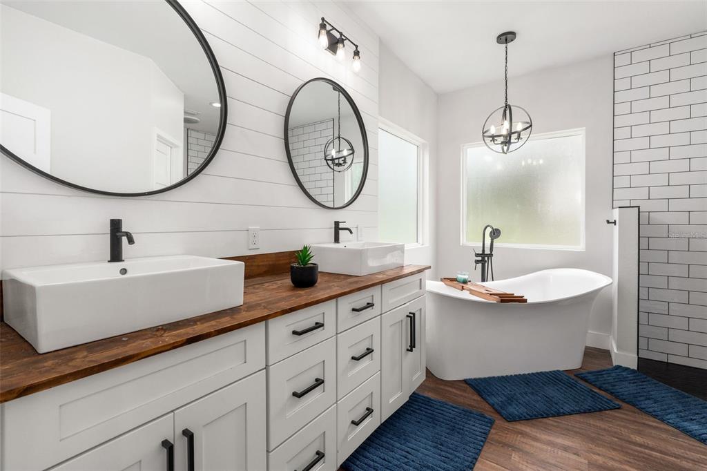 15971 Southeast 64th Street Lake Butler, FL 32054 - Photo 14 of 44 a bathroom with a double vanity sink and a mirror