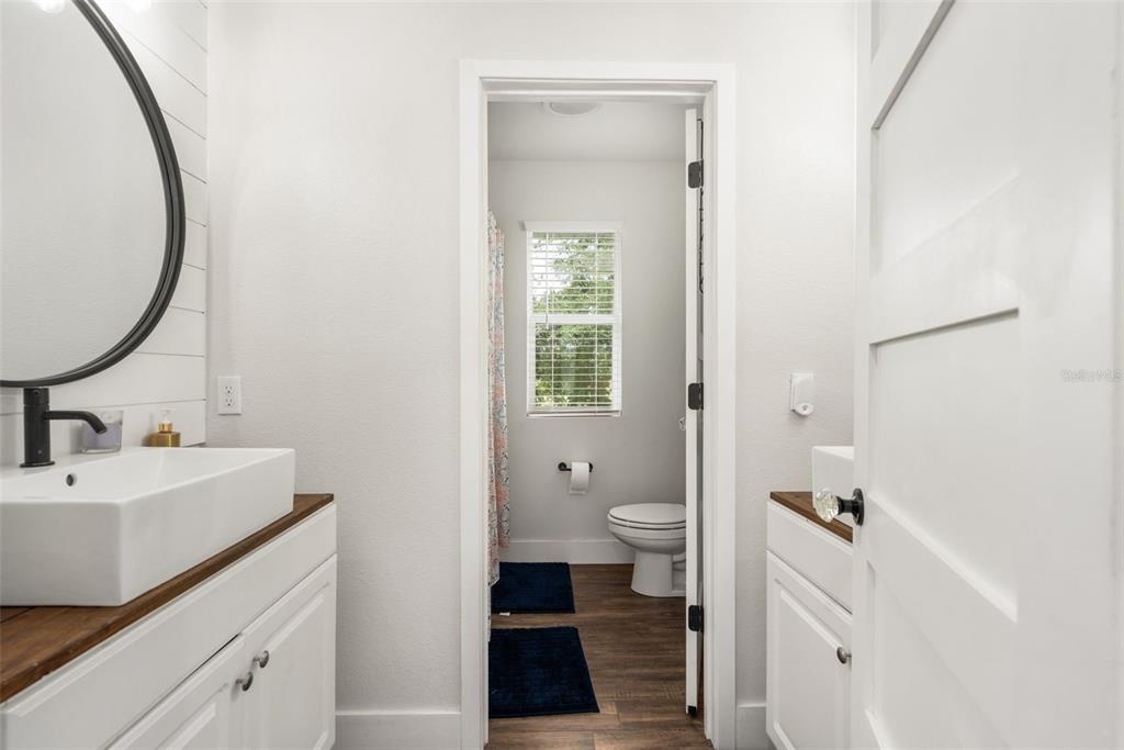 15971 Southeast 64th Street Lake Butler, FL 32054 - Photo 22 of 44 a bathroom with a sink a toilet and a mirror