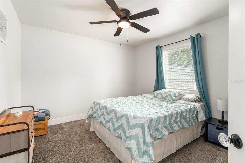 15971 Southeast 64th Street Lake Butler, FL 32054 - Photo 25 of 44 a bedroom with a bed and a window