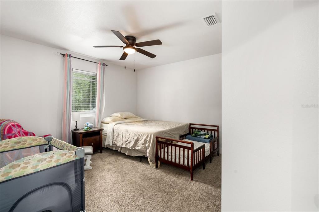 15971 Southeast 64th Street Lake Butler, FL 32054 - Photo 26 of 44 a bedroom with a bed and a window