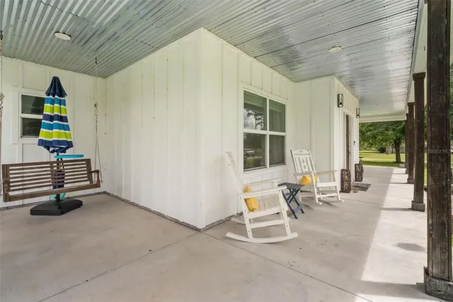 a front view of house with yard and swimming pool