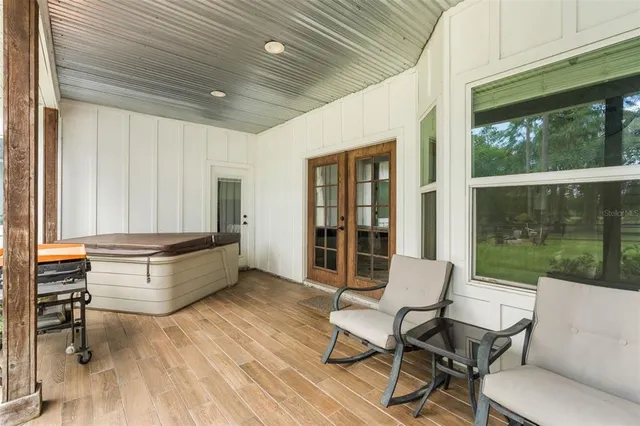 a house view with a seating space and a ocean view