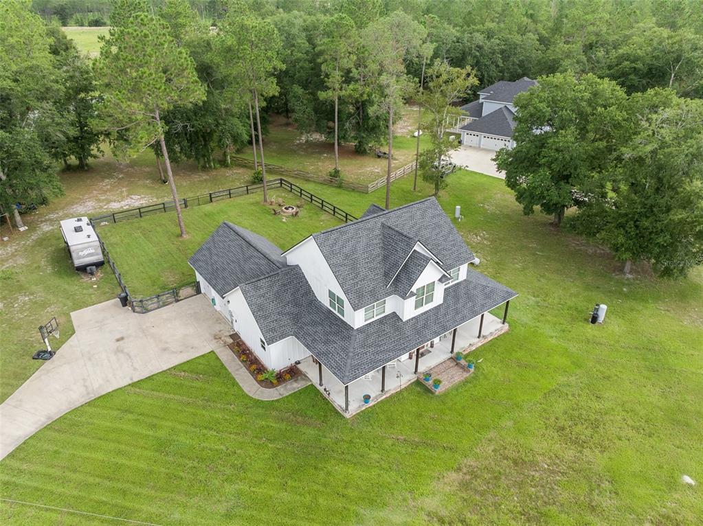 15971 Southeast 64th Street Lake Butler, FL 32054 - Photo 41 of 44 an aerial view of a house with swimming pool and a yard