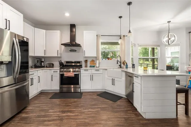 a kitchen with a stove a sink and a refrigerator
