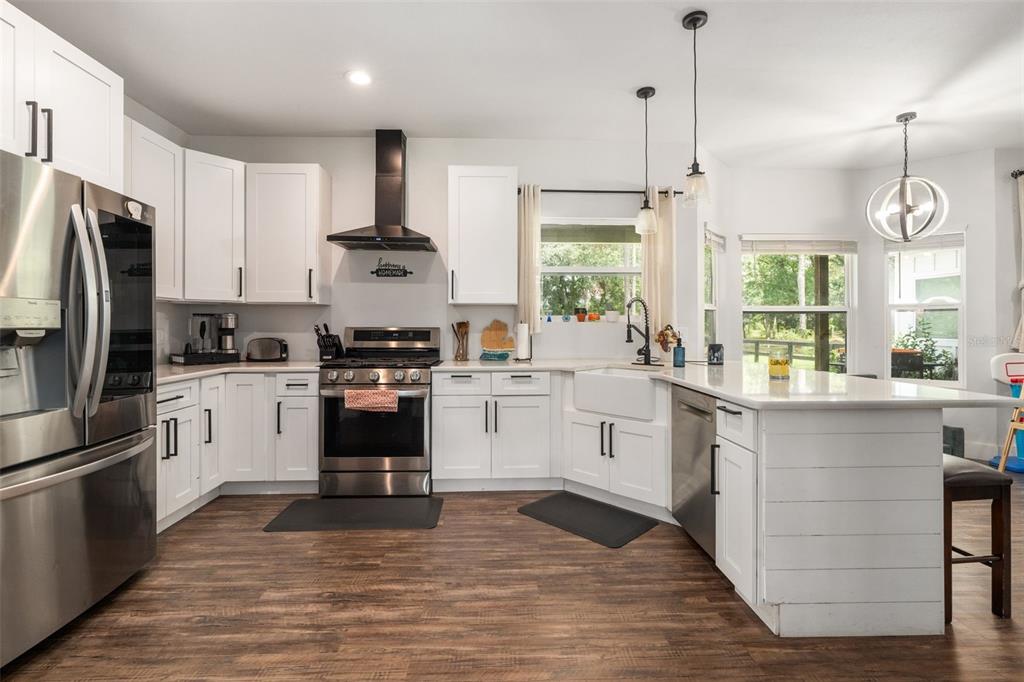 15971 Southeast 64th Street Lake Butler, FL 32054 - Photo 7 of 44 a kitchen with a stove a sink and a refrigerator