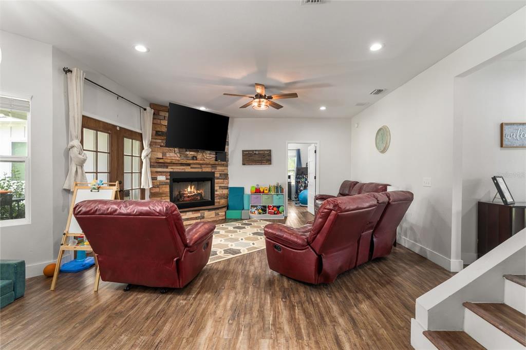 15971 Southeast 64th Street Lake Butler, FL 32054 - Photo 9 of 44 a living room with furniture a flat screen tv and a fireplace