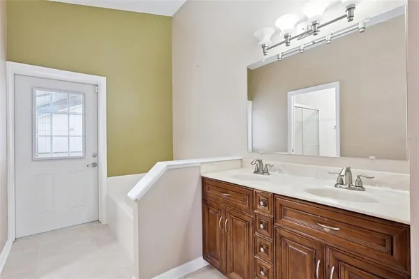 a bathroom with a sink toilet vanity and shower