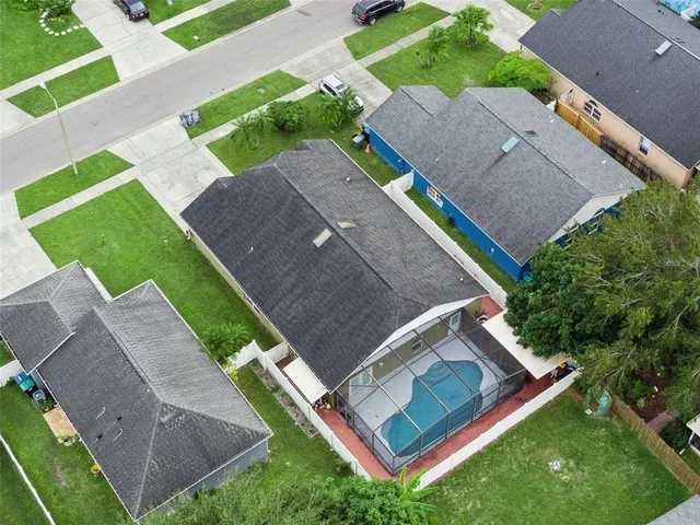 an aerial view of a house with a yard