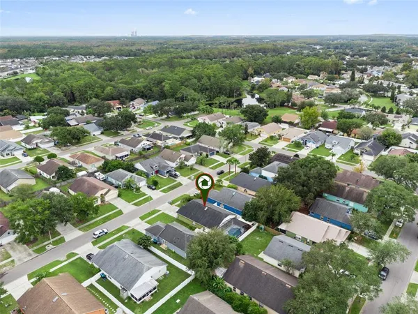 an aerial view of residential houses with outdoor space and river