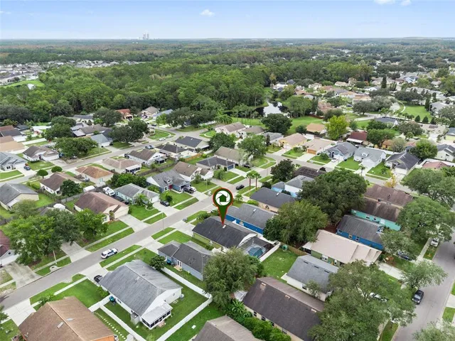 an aerial view of residential houses with outdoor space and river