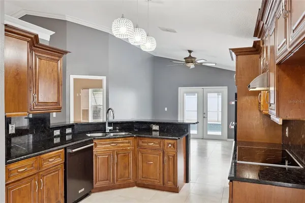 a kitchen with stainless steel appliances granite countertop a stove a sink and a microwave
