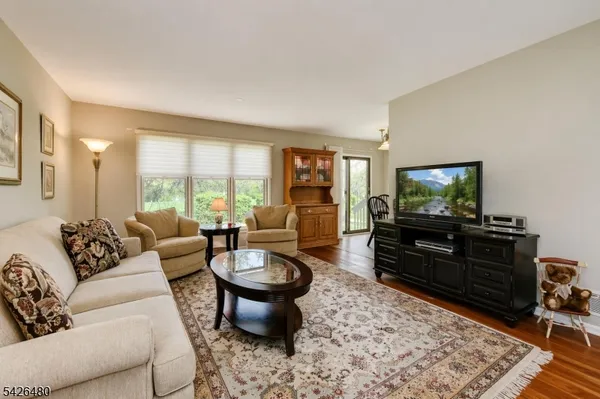 a dining room with furniture window and wooden floor