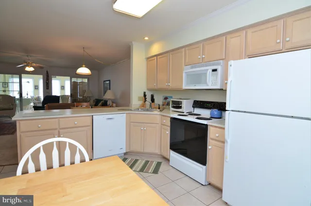 a kitchen with a refrigerator sink and cabinets
