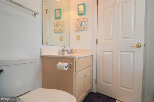 a bathroom with a sink a toilet and shower curtain