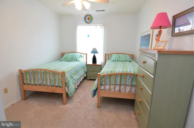 a bedroom with a bed and a baby crib