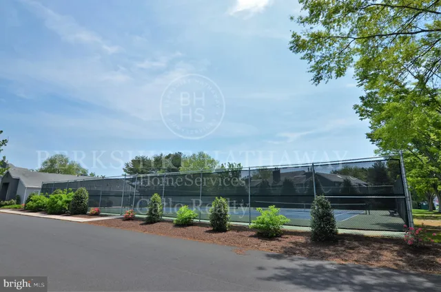 a bench is sitting in front of a house
