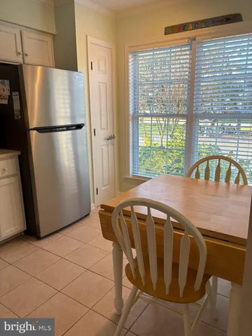 a kitchen with a refrigerator a stove and a window